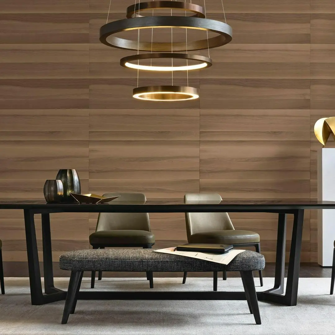 Modern luxury dining table set with tiered ring chandelier lighting at Qasr Al-Ajwaad, premium Italian furniture in Muscat, Oman.