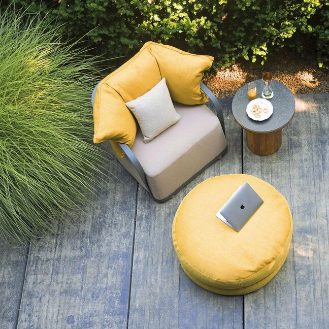 Modern designer outdoor armchair and yellow pouf for luxury patios and garden terraces, premium furniture in Oman - Ajwaad Palace.
