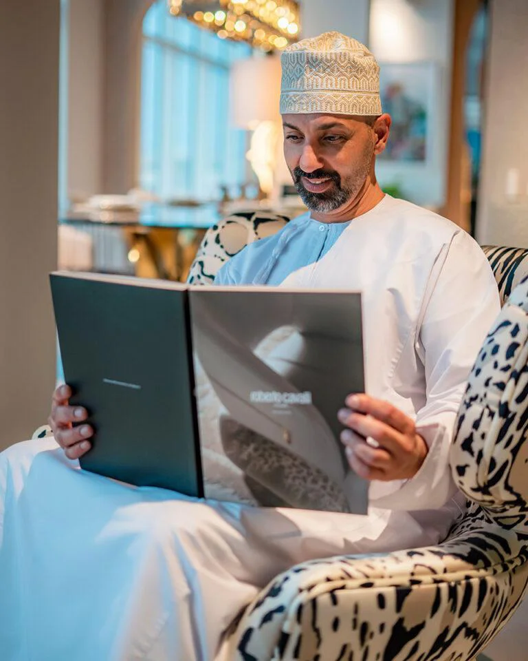 Omani gentleman reviewing the Roberto Cavalli Home Interiors collection at Ajwaad Palace luxury furniture showroom in Muscat, Oman.